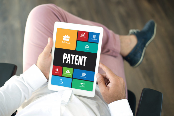 Firdapse | Lambert-Eaton News | Patents | Person holds a computer tablet displaying the word 'patent'