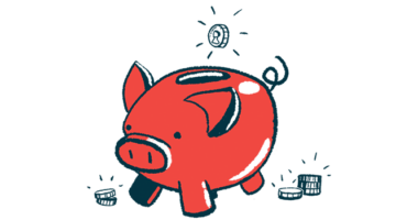 A coin is seen poised over the top slot of a pig-shaped bank.