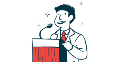 A man speaks at a podium using a microphone.