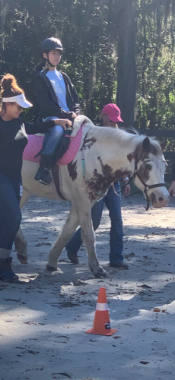 relationships | Lambert-Eaton News | Grace rides the horse Dolly while being assisted by a staff member of the nonprofit Grace Under the Oaks.