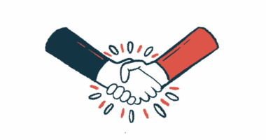 Two hands are seen clasped together in a handshake.