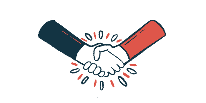 Two hands are seen clasped together in a handshake.